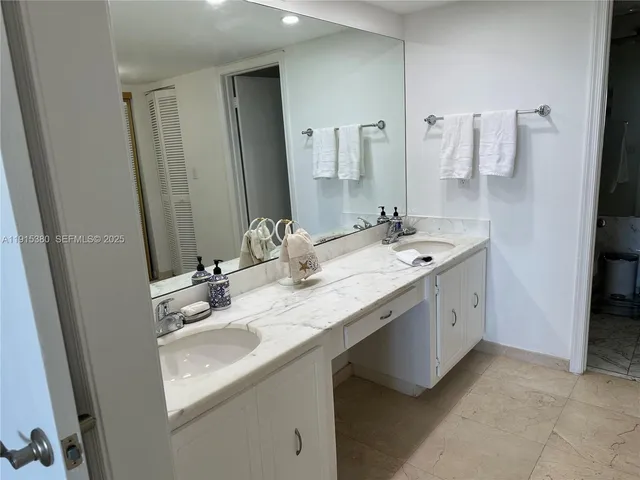 a bathroom with a double vanity sink a mirror and a