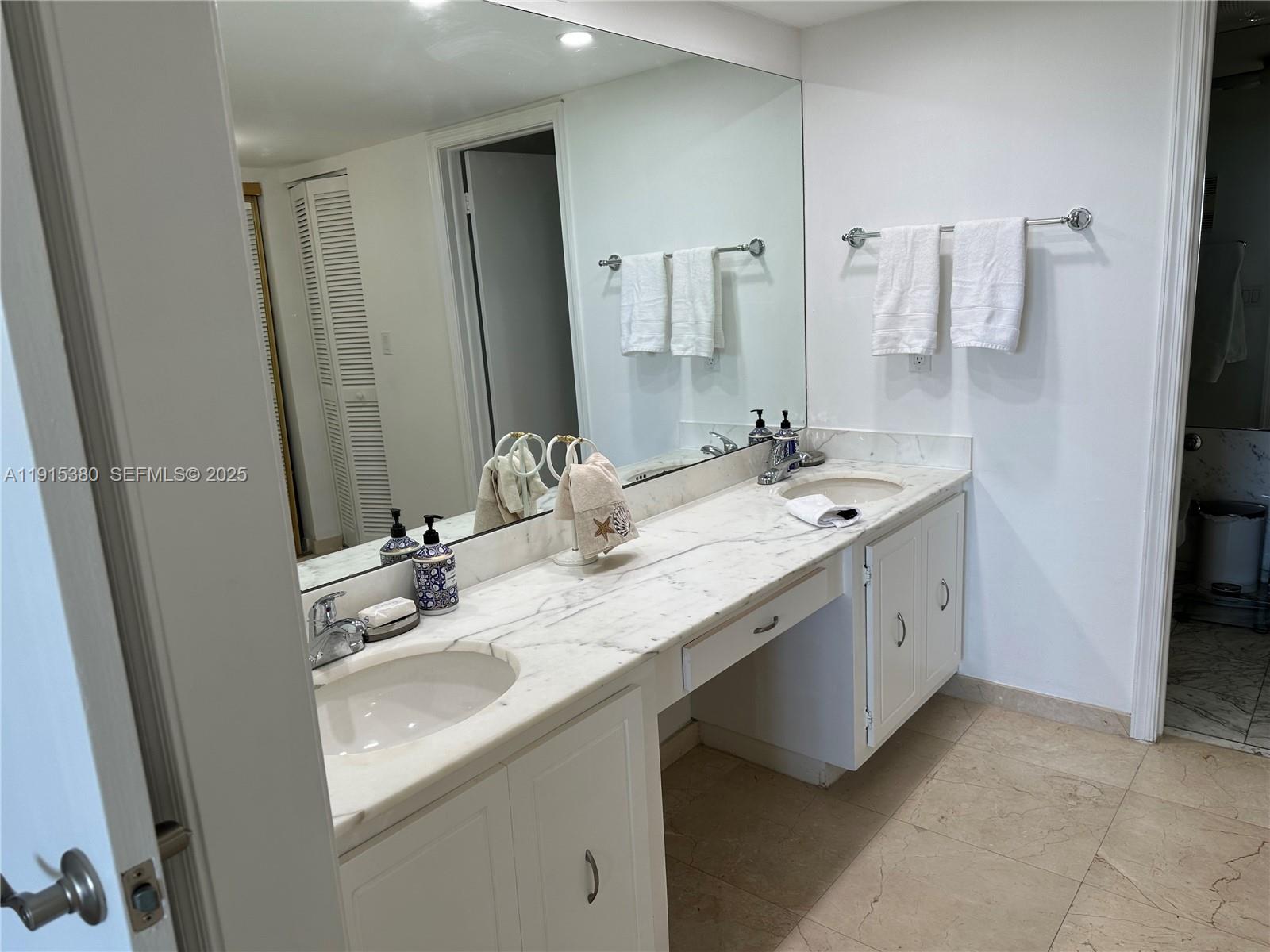 199 Ocean Ln Drive, Unit 1004 Key Biscayne, FL 33149 - Photo 8 of 12 a bathroom with a double vanity sink a mirror and a