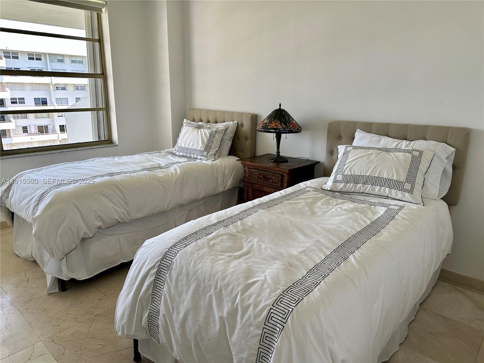 199 Ocean Ln Drive, Unit 1004 Key Biscayne, FL 33149 - Photo 9 of 12 a bedroom with two beds and a window
