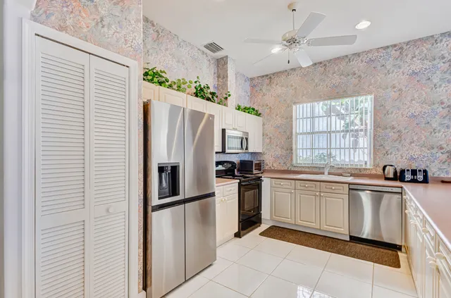 a kitchen with granite countertop stainless steel appliances a sink and counter space