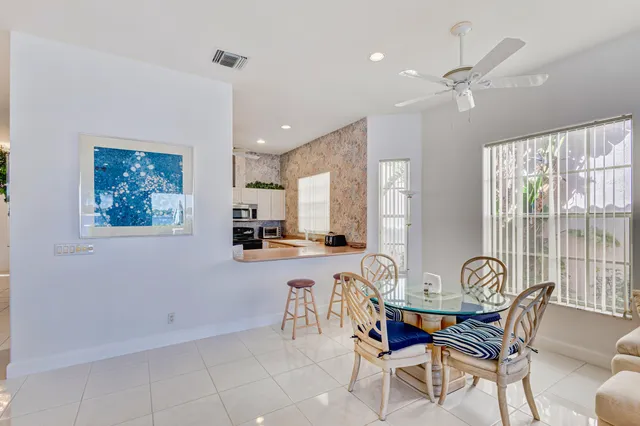a view of a dining room with furniture and a large window