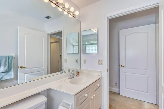 a bathroom with a sink vanity granite and a mirror