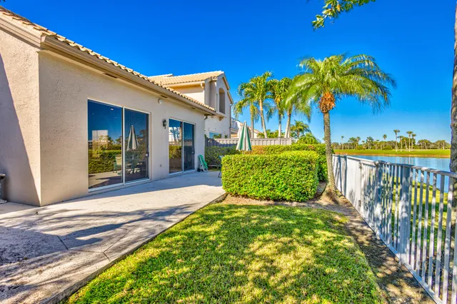 a view of a house with balcony yard and swimming pool