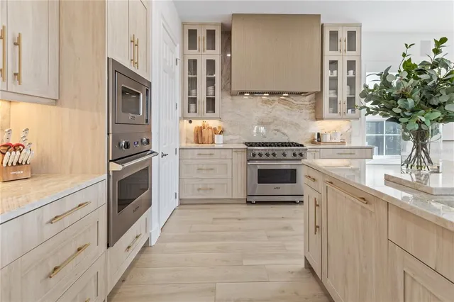 a kitchen with cabinets stainless steel appliances and a counter space