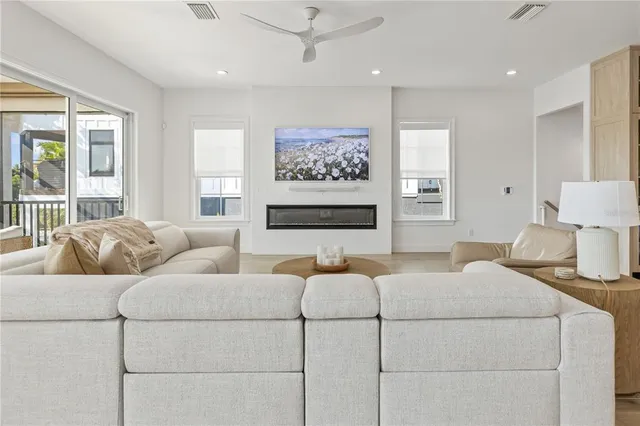 a bedroom with furniture and a large window