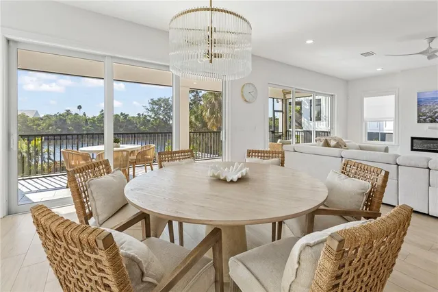 a view of a dining room with furniture large windows and wooden floor