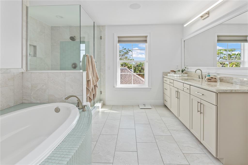8008 Midnight Pass Road Sarasota, FL 34242 - Photo 25 of 61 a spacious bathroom with a tub sink and mirror