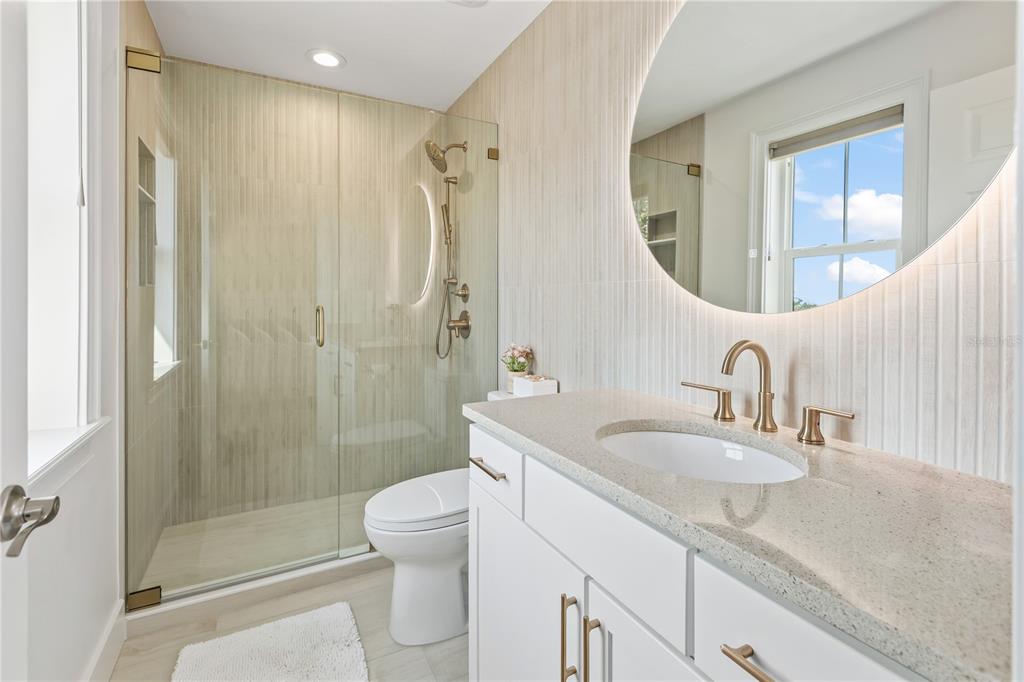 8008 Midnight Pass Road Sarasota, FL 34242 - Photo 28 of 61 a bathroom with a granite countertop sink a toilet and shower