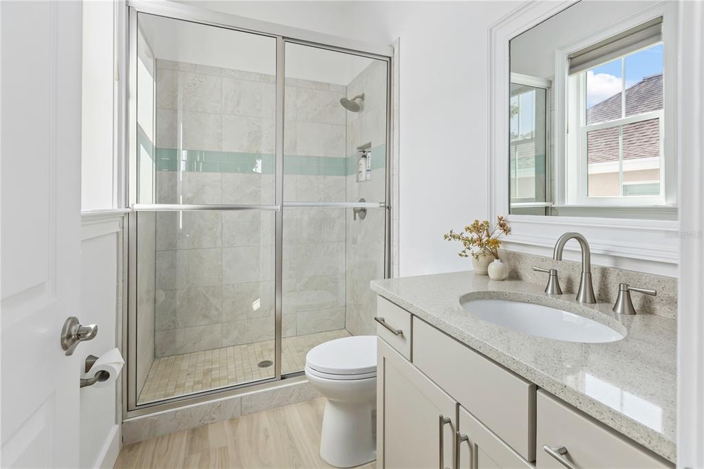8008 Midnight Pass Road Sarasota, FL 34242 - Photo 34 of 61 a bathroom with a granite countertop sink a toilet and shower