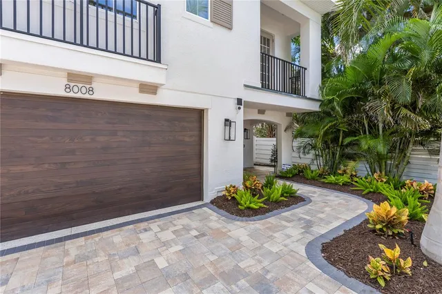 a front view of a house with a yard and tree s