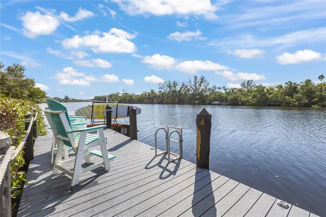 an aerial view of lake and residential houses with outdoor space