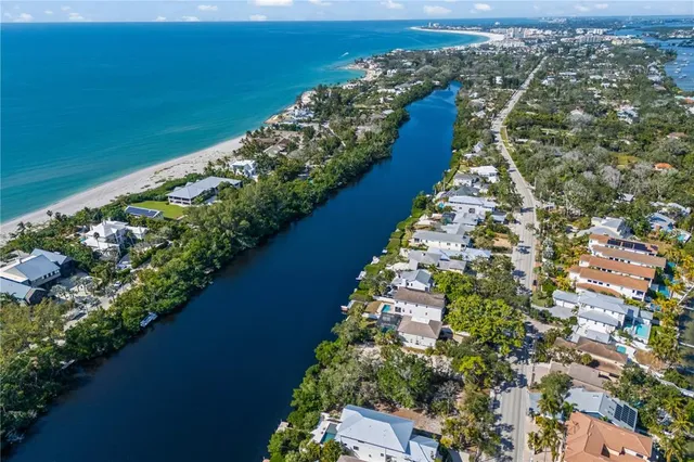 an aerial view of a house with outdoor space and lake view