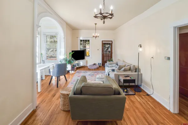 a kitchen with a refrigerator a stove a sink dishwasher and wooden cabinets with wooden floor