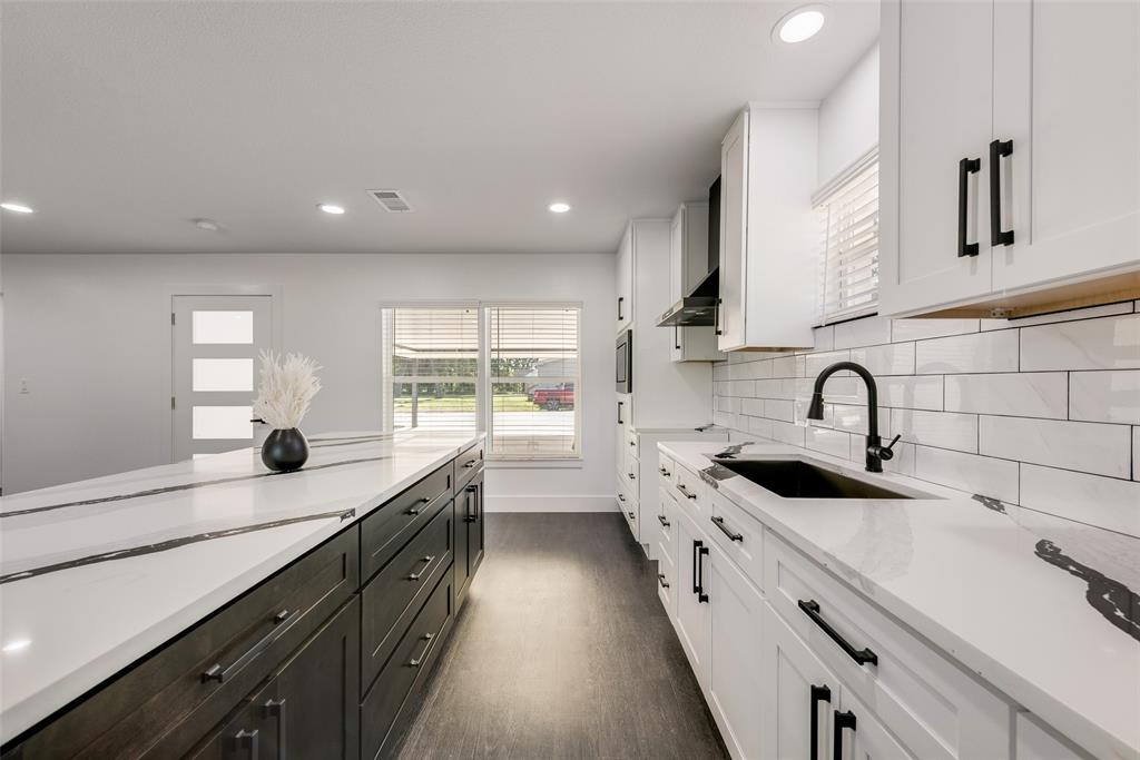 13827 Hiram Road Wills Point, TX 75169 - Photo 9 of 39 a kitchen with stainless steel appliances a sink stove and cabinets