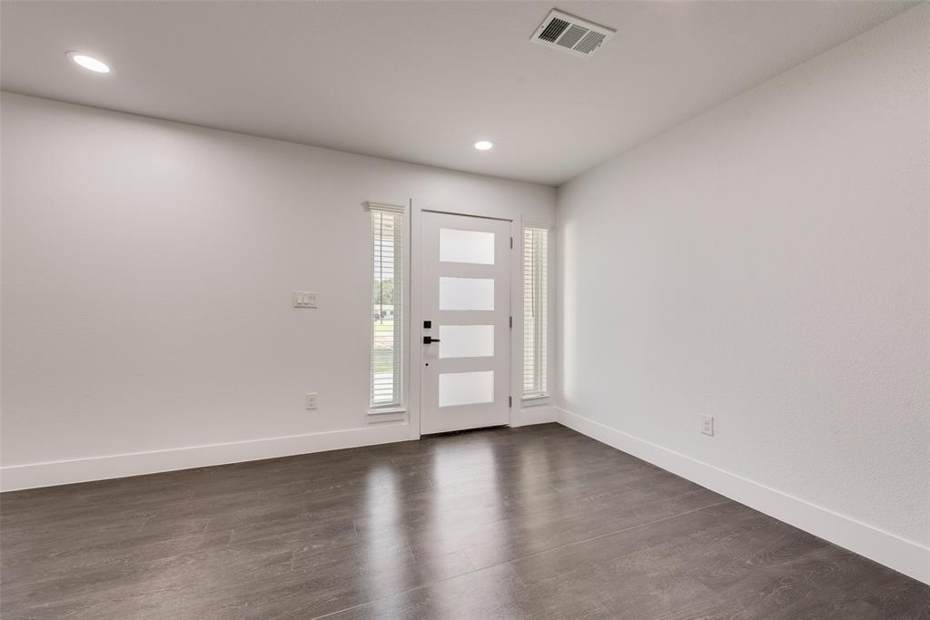 13827 Hiram Road Wills Point, TX 75169 - Photo 10 of 39 an empty room with wooden floor and windows