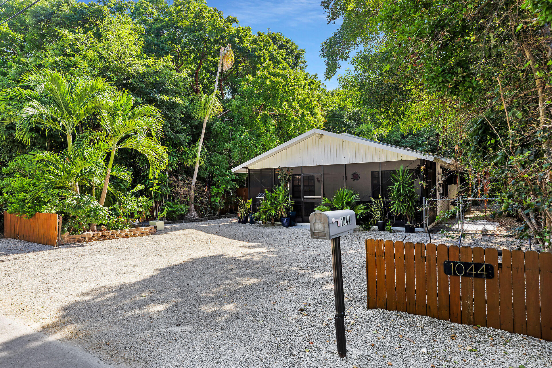 a patio with a table and chairs under an umbrella