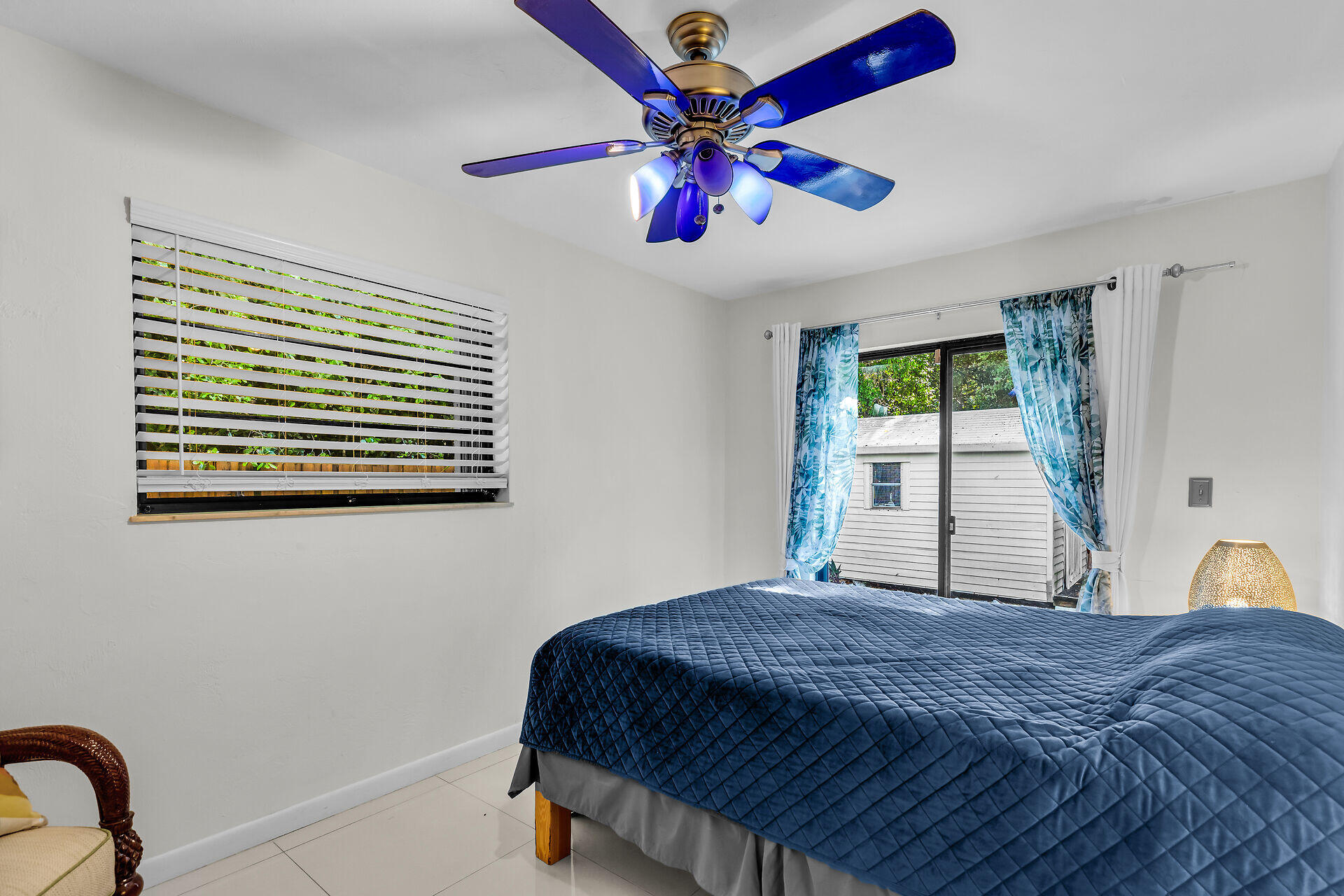1044 Gibraltar Road Key Largo, FL 33037 - Photo 14 of 29 a bedroom with a bed and a chandelier