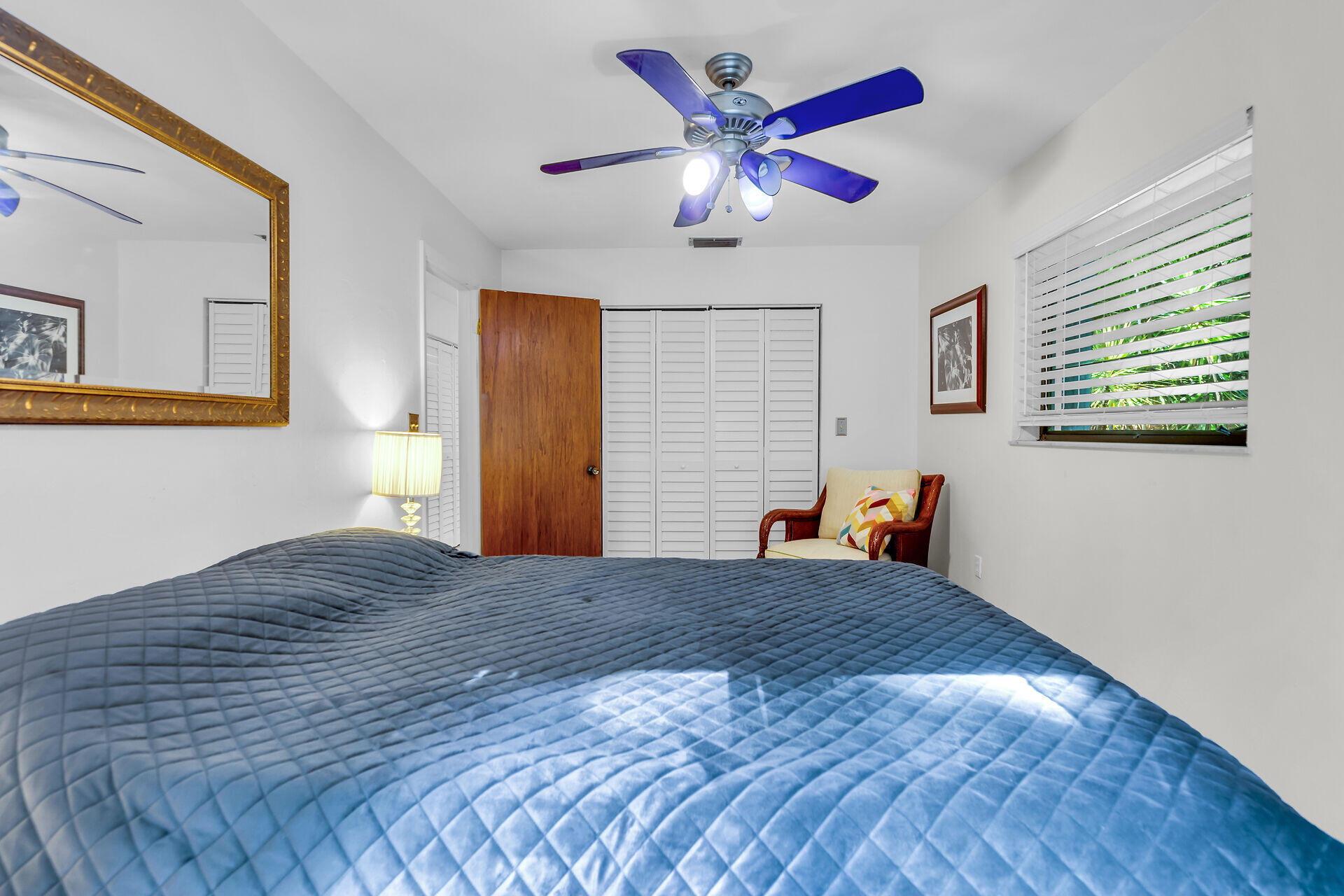 1044 Gibraltar Road Key Largo, FL 33037 - Photo 16 of 29 a bedroom with a bed and a chandelier