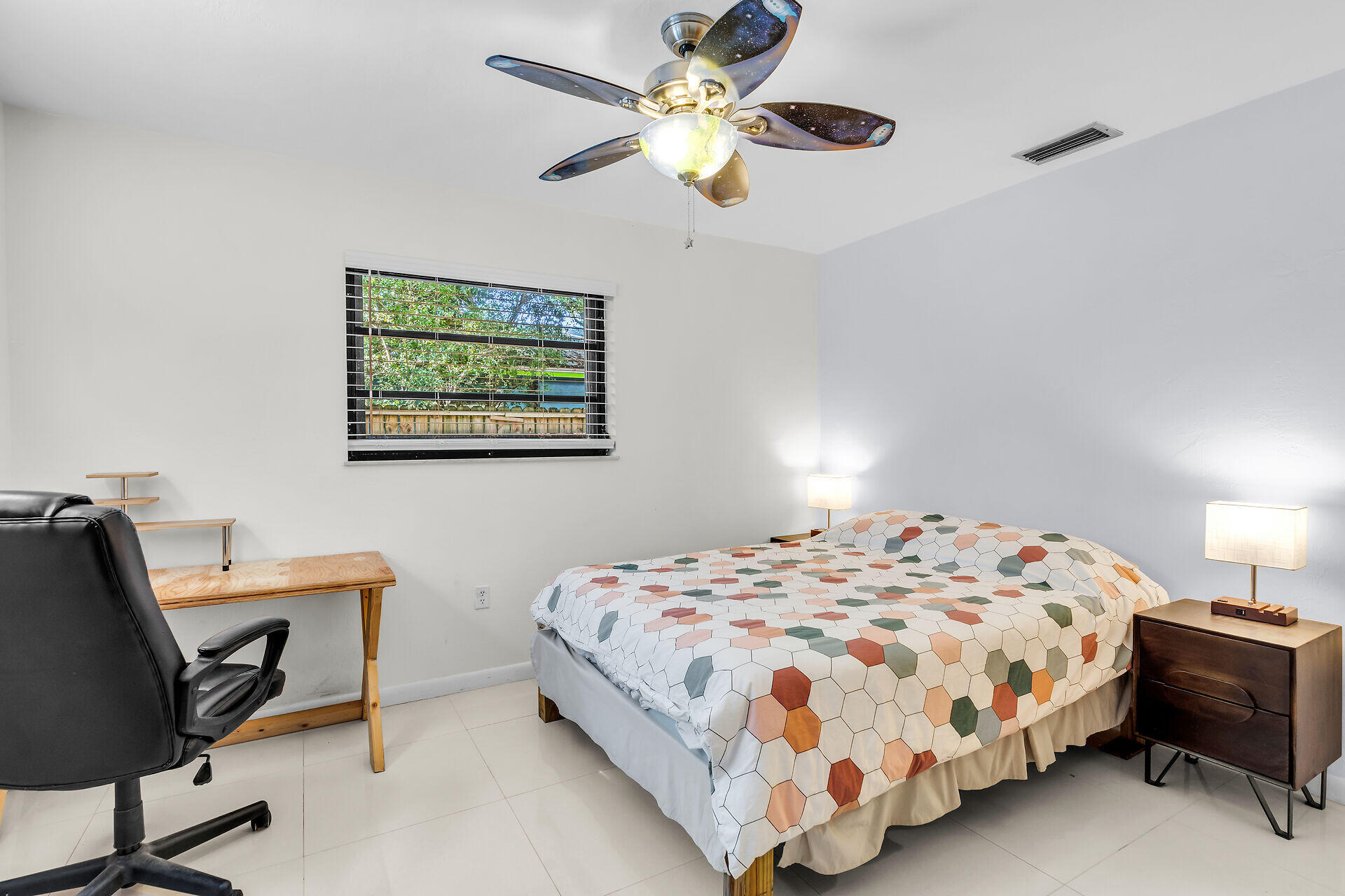 1044 Gibraltar Road Key Largo, FL 33037 - Photo 20 of 29 a bedroom with a bed and a chandelier