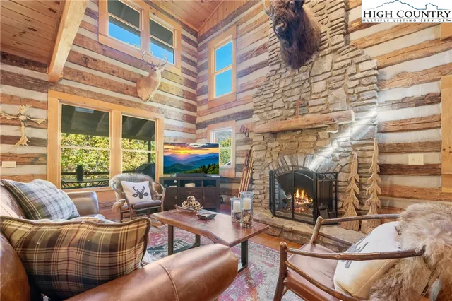 a living room with furniture a fireplace and a large window