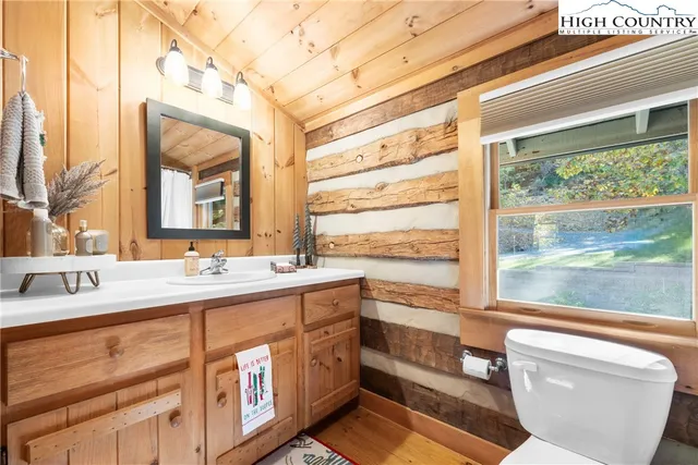 a bathroom with a granite countertop sink mirror and a bathtub
