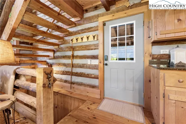 a view of a room with wooden floor and windows