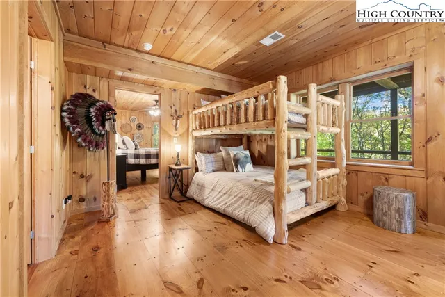 a bed room with a bed and a large window