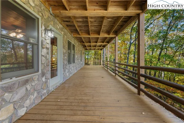 a view of a porch with wooden floor and windows