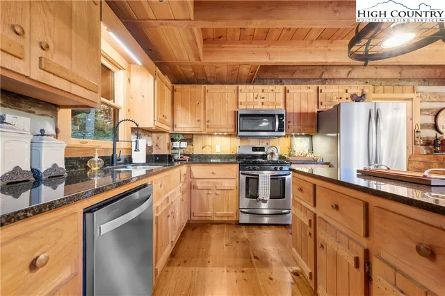 a kitchen with stainless steel appliances a stove sink and cabinets