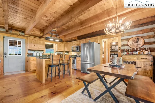 a dining room with furniture and wooden floor