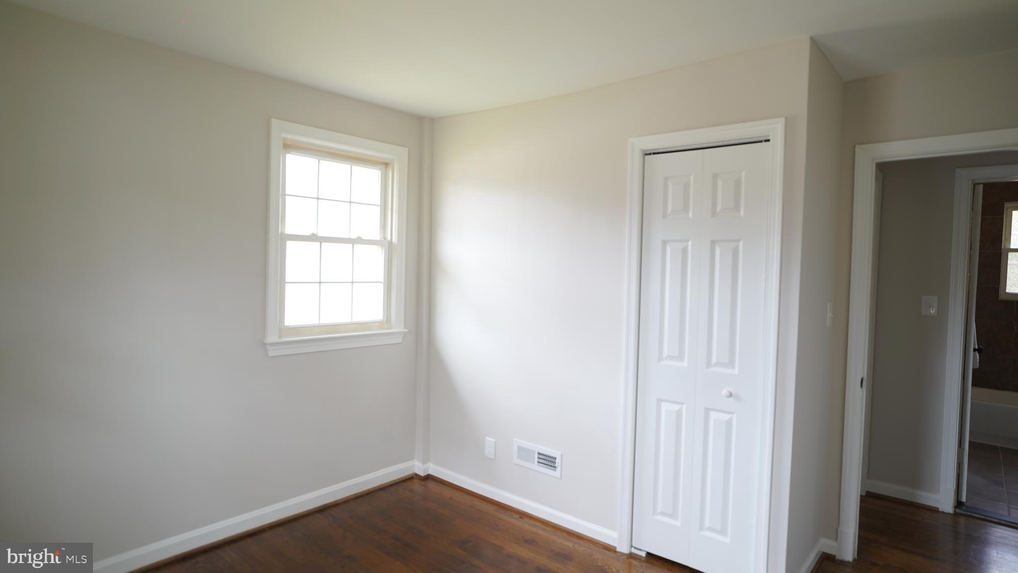 9300 Worrell Avenue Lanham, MD 20706 - Photo 18 of 63 an empty room with wooden floor closet and windows