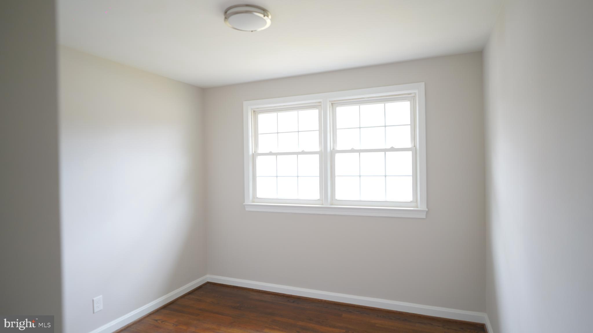 9300 Worrell Avenue Lanham, MD 20706 - Photo 20 of 63 an empty room with wooden floor and windows