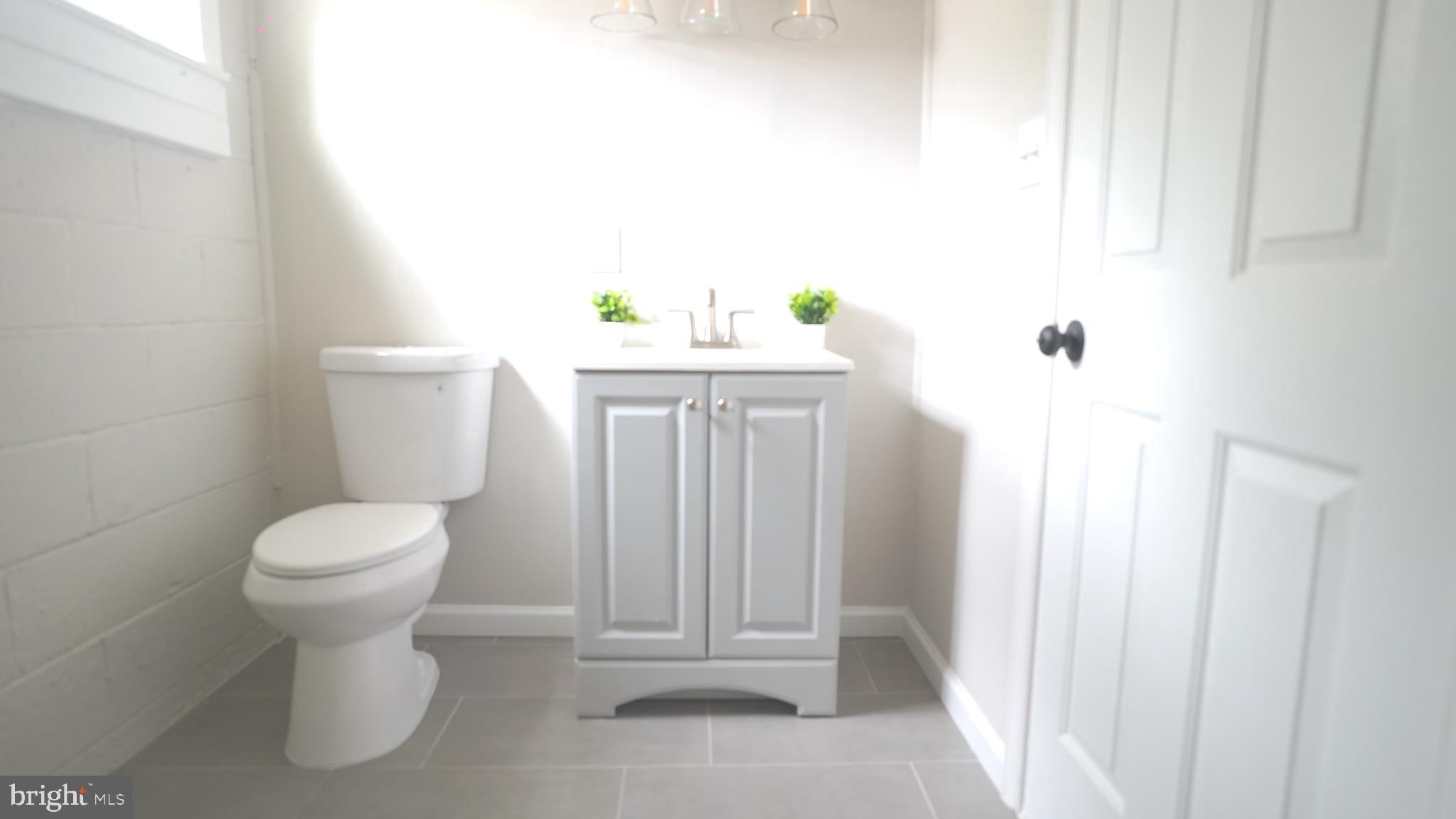 9300 Worrell Avenue Lanham, MD 20706 - Photo 27 of 63 a bathroom with a sink a toilet and a window