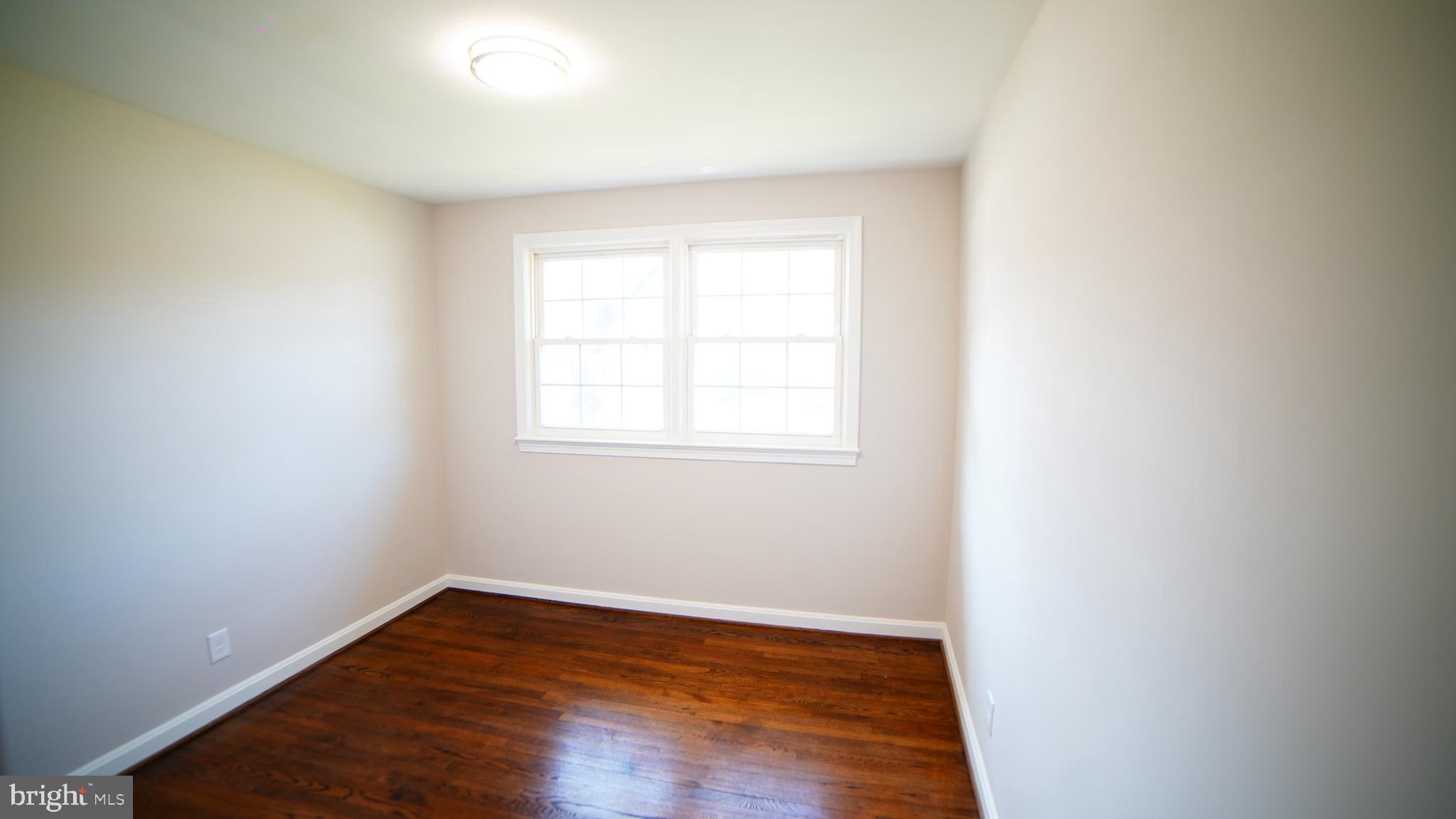 9300 Worrell Avenue Lanham, MD 20706 - Photo 51 of 63 a view of an empty room with wooden floor and a window