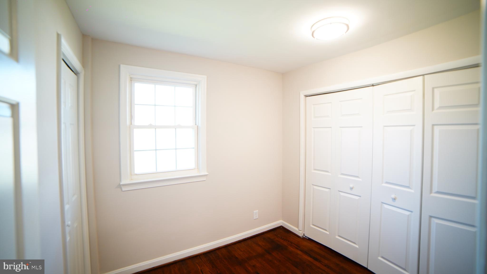 9300 Worrell Avenue Lanham, MD 20706 - Photo 53 of 63 a view of an empty room with wooden floor and a window