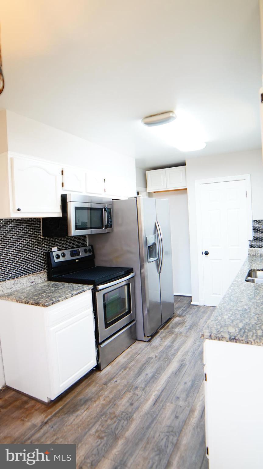 9300 Worrell Avenue Lanham, MD 20706 - Photo 57 of 63 a kitchen with stainless steel appliances granite countertop a sink and a refrigerator