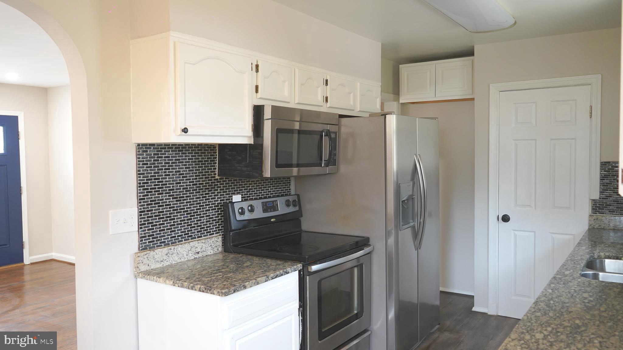 9300 Worrell Avenue Lanham, MD 20706 - Photo 7 of 63 a kitchen with stainless steel appliances granite countertop a refrigerator and a sink