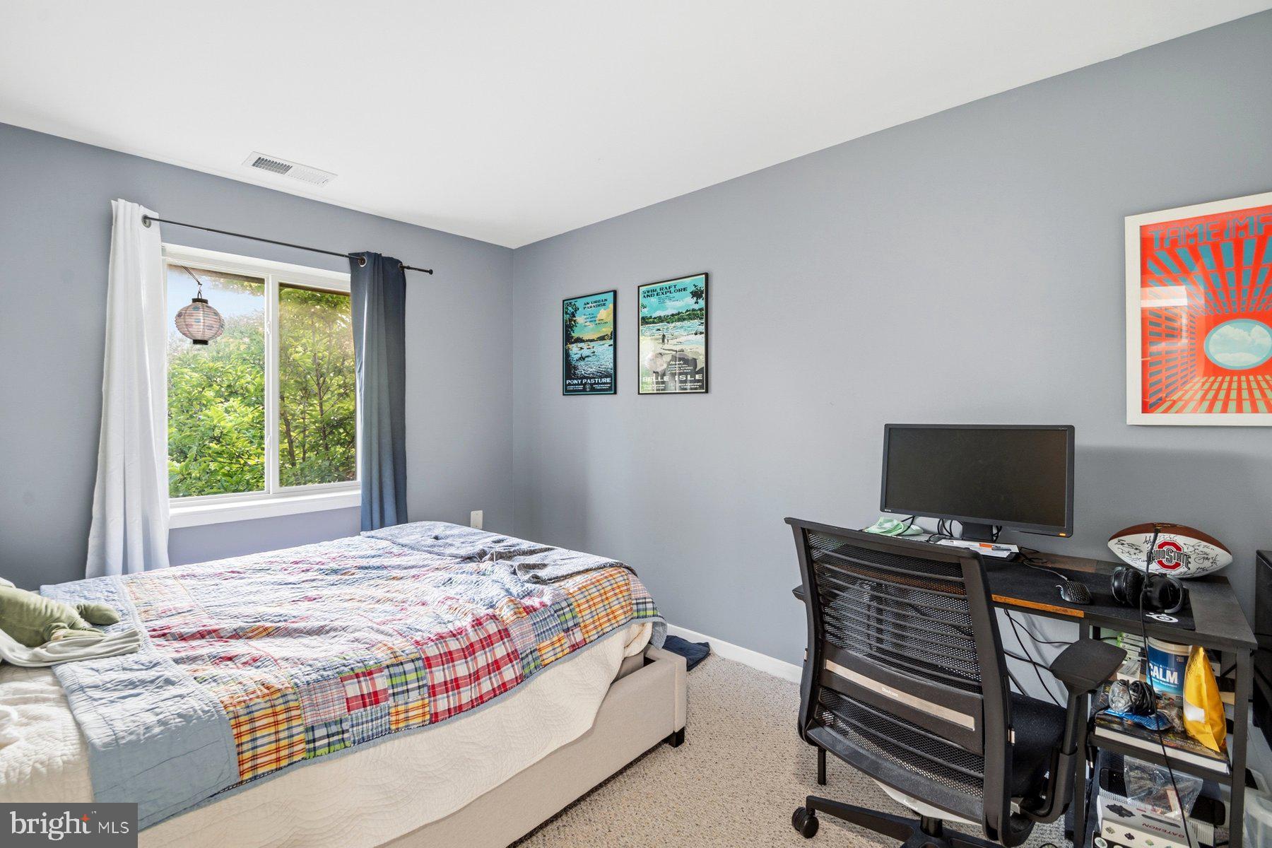 642 South Charles Street, Unit R 22 Baltimore, MD 21230 - Photo 16 of 26 a bedroom with a bed and a flat screen tv