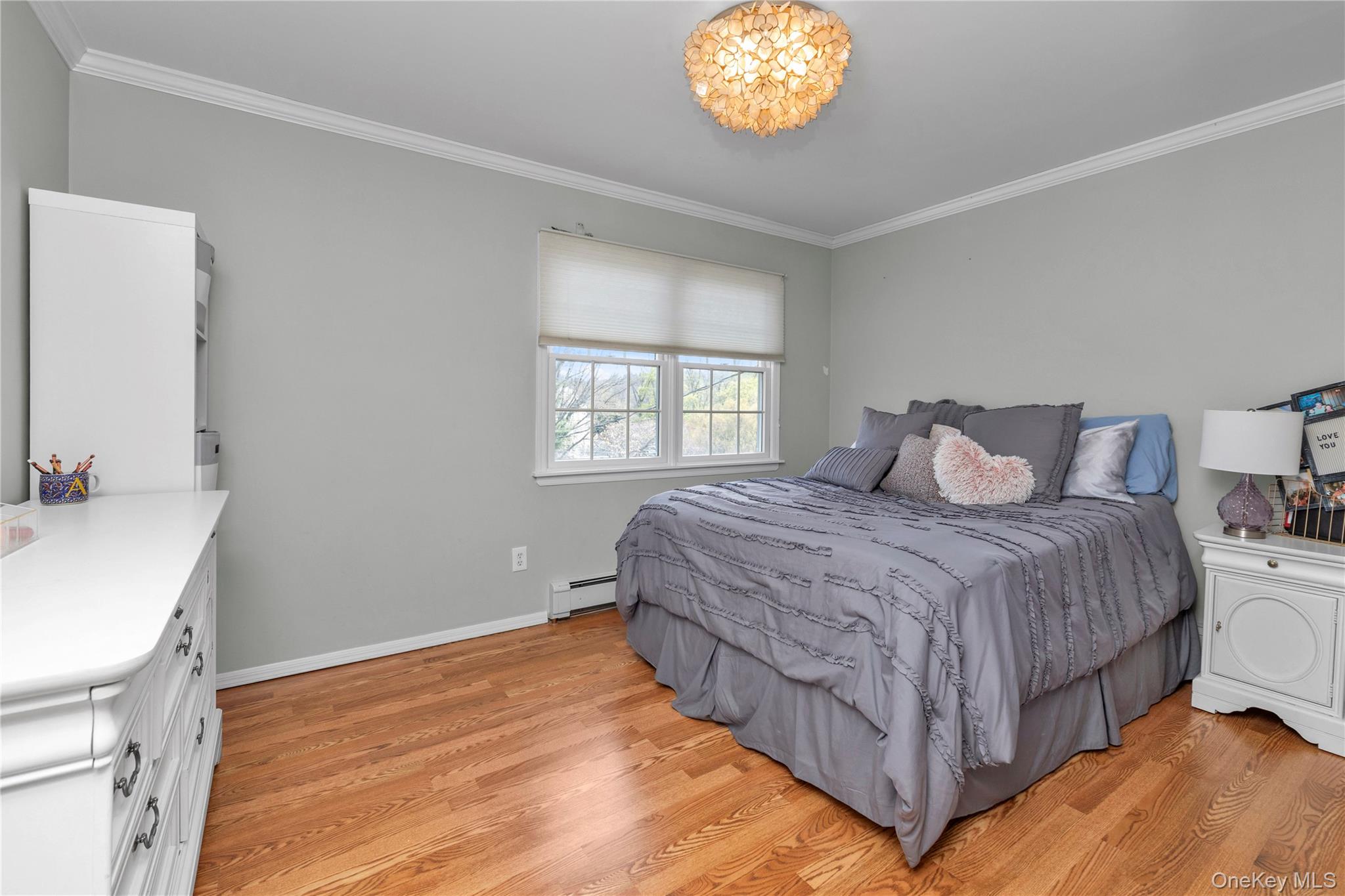 23 Grove Street Cold Spring Harbor, NY 11724 - Photo 15 of 21 a bedroom with a bed and a sink