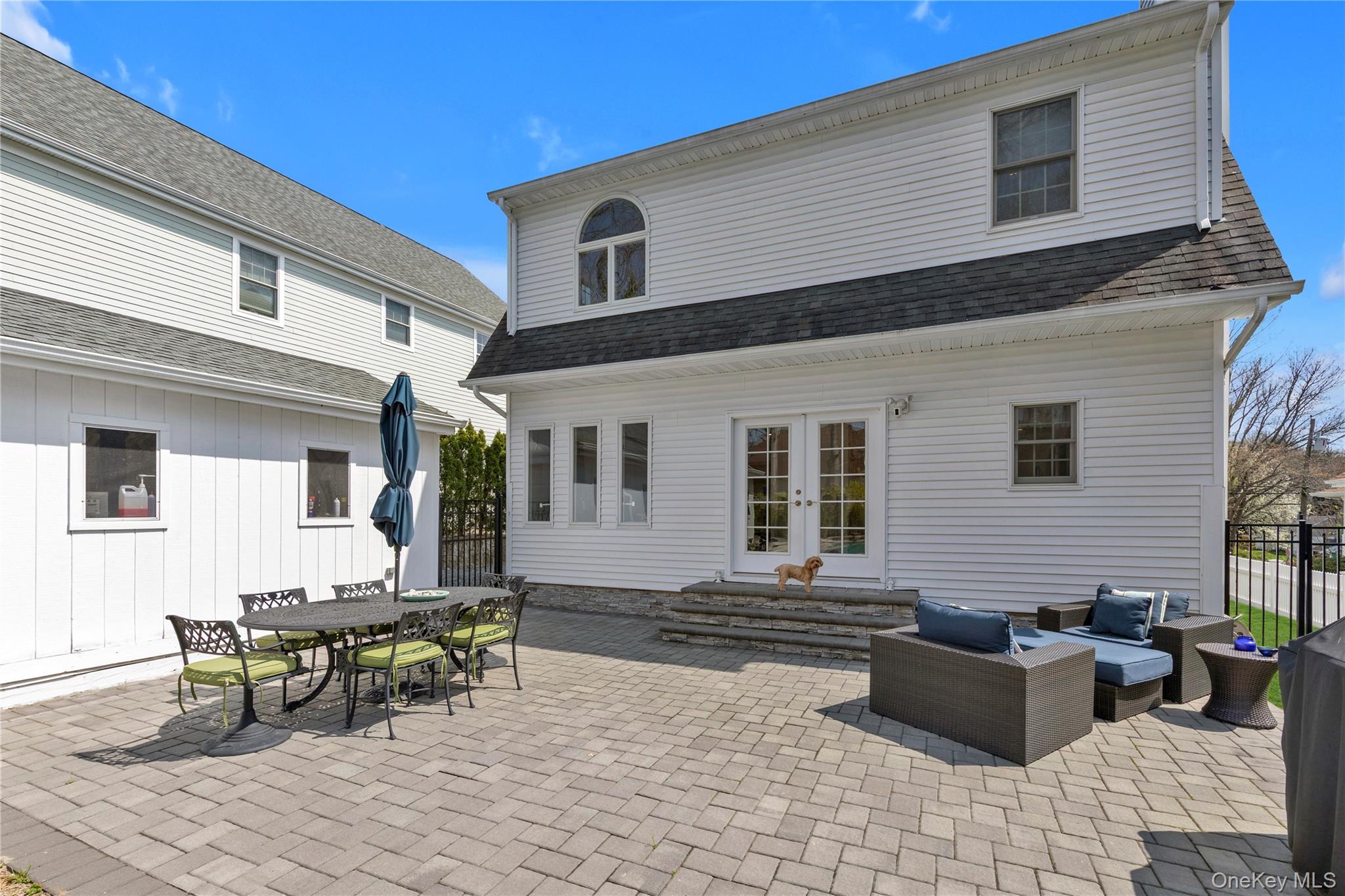 23 Grove Street Cold Spring Harbor, NY 11724 - Photo 18 of 21 a backyard of a house with table and chairs