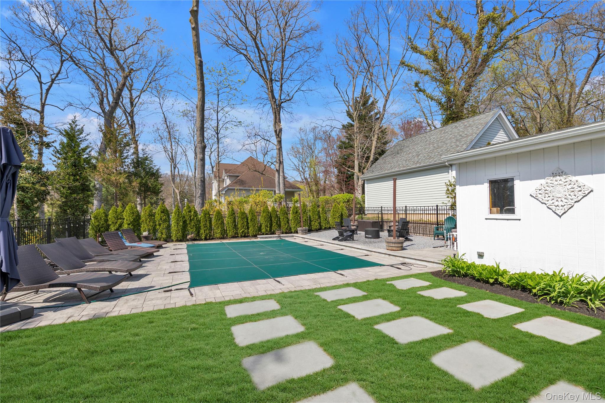 23 Grove Street Cold Spring Harbor, NY 11724 - Photo 19 of 21 a view of a patio with table and chairs under an umbrella