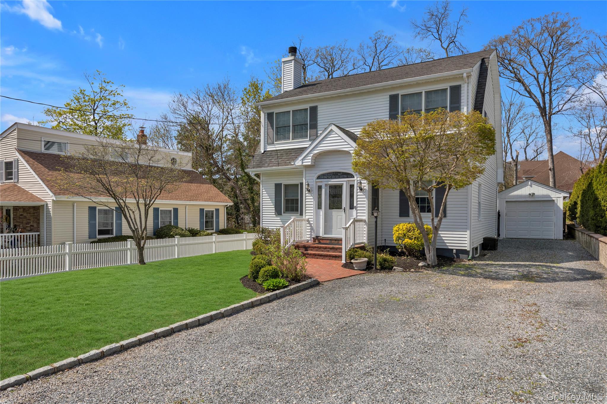 23 Grove Street Cold Spring Harbor, NY 11724 - Photo 21 of 21 a front view of a house with garden