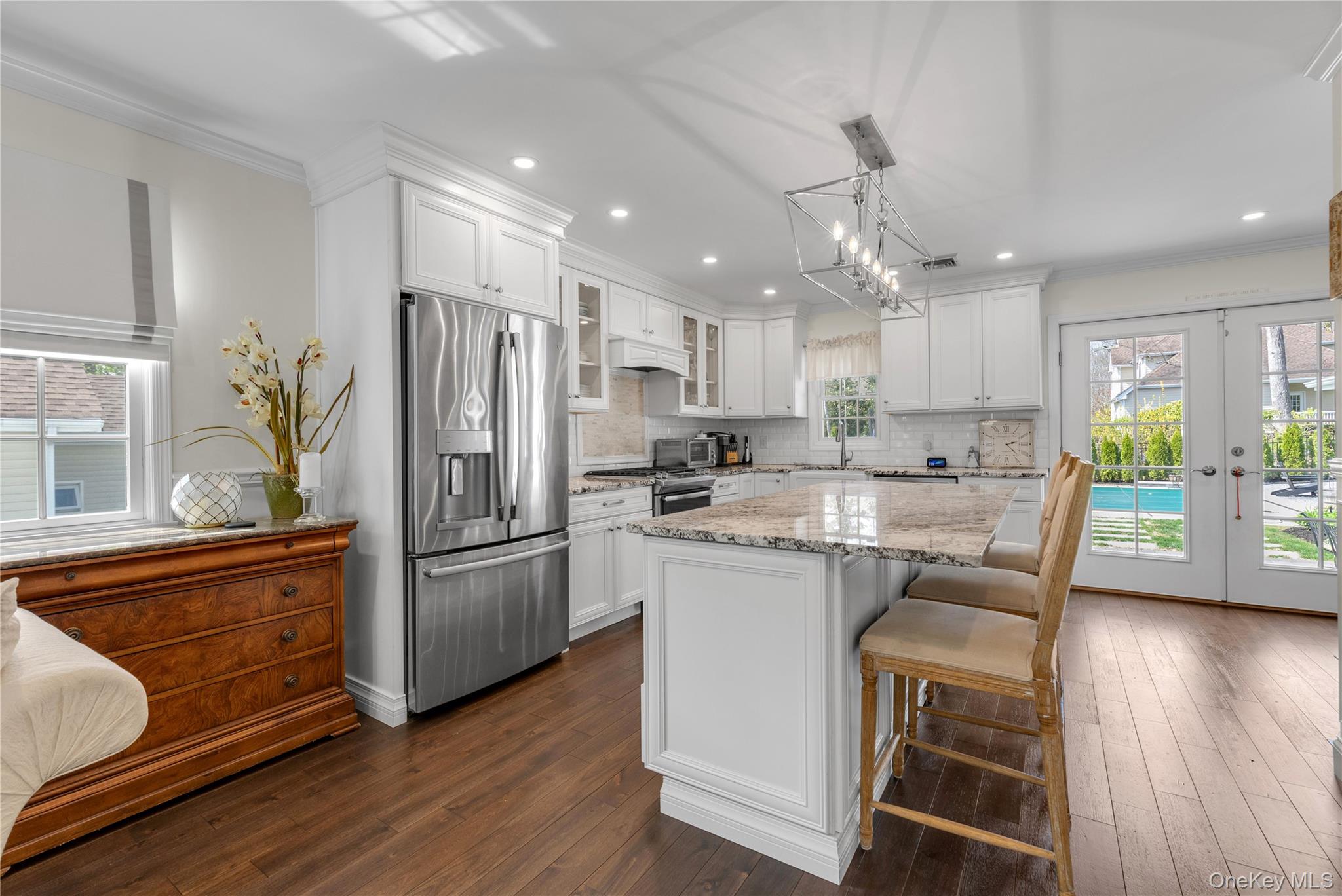 23 Grove Street Cold Spring Harbor, NY 11724 - Photo 9 of 21 a kitchen with stainless steel appliances granite countertop a refrigerator a sink dishwasher a stove and white cabinets with wooden floor