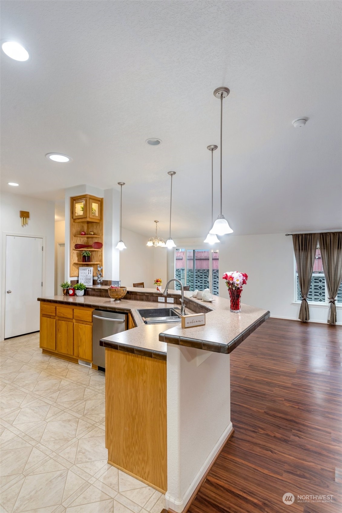 3324 206th Place Southeast Bothell, WA 98012 - Photo 11 of 34 a kitchen with a stove a sink a dining table and chairs