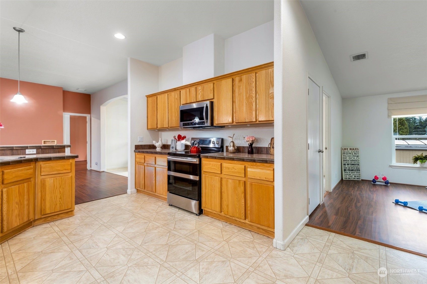 3324 206th Place Southeast Bothell, WA 98012 - Photo 13 of 34 a kitchen with stainless steel appliances granite countertop a stove a sink and a refrigerator