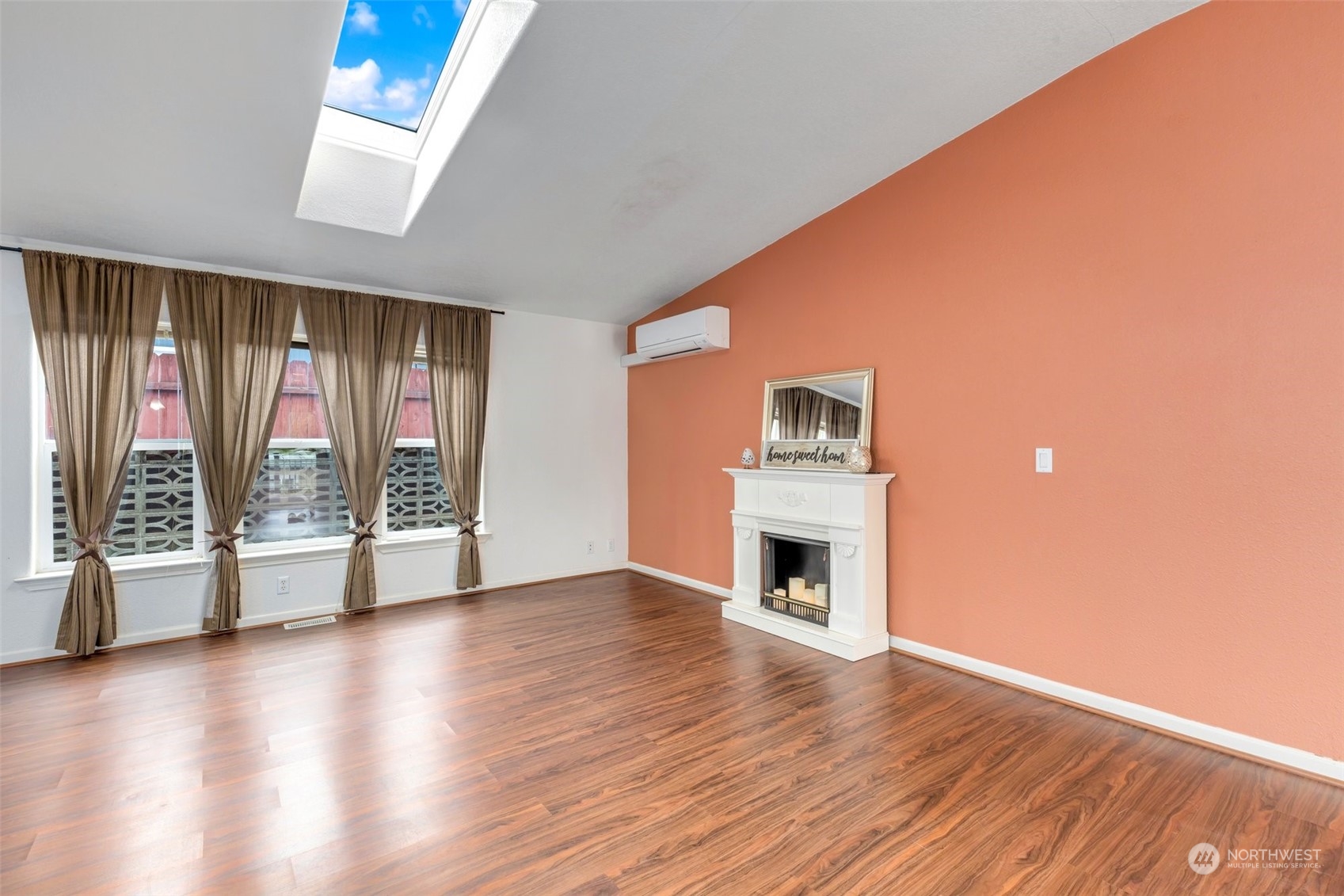 3324 206th Place Southeast Bothell, WA 98012 - Photo 9 of 34 an empty room with wooden floor fireplace and windows
