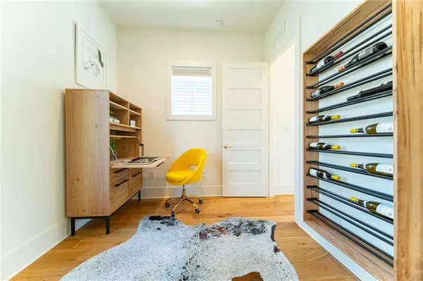 a view of a bedroom with a bed and wooden floor