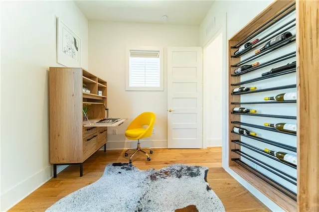 a view of a bedroom with a bed and wooden floor