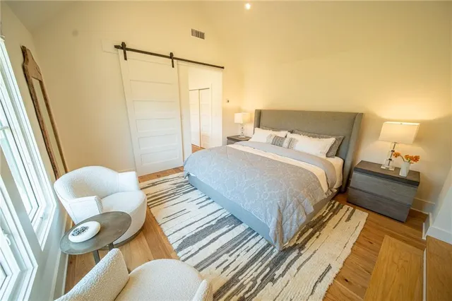 a bedroom with bed and a window