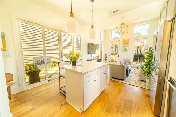 a large white kitchen with a large window